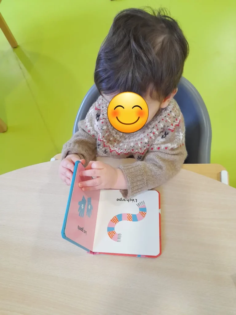 Enfant présentant un livre pour tout-petits déjà déballé
